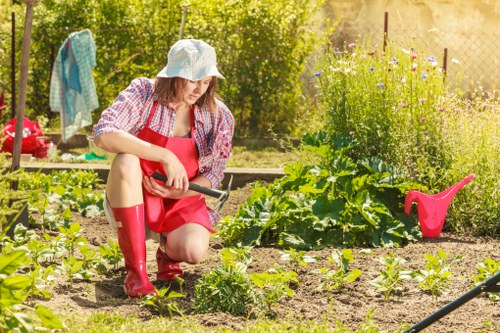 Professional landscapers working on a residential garden in Wood Green